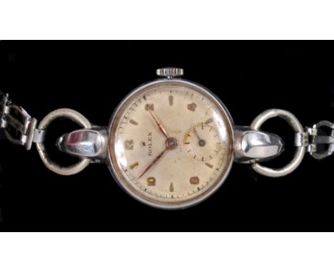 A Lady's mid 20th Century Rolex Wristwatch, the champagne dial with alternating arabic numerals and baton markers and subsidi