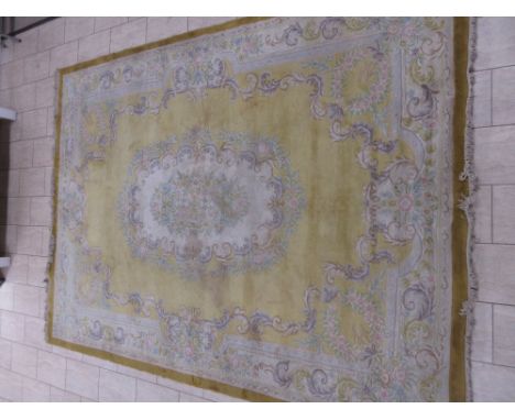 A large Chinese Carpet with scrolled floral design on a gold ground, 12ft x 9ft