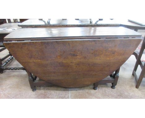 A 17th Century oak oval Gate-leg Table fitted single drawer on gun barrel turned and square legs united by square stretchers,