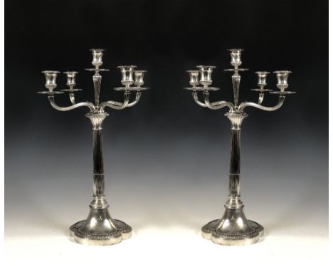 A fine pair of Victorian silver four branch, five light Candelabra with fluted columns, beaded trefoil bases with crest and p