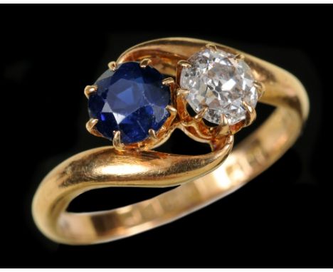 A Sapphire and Diamond crossover Ring claw-set round sapphire and old-cut diamond in 18ct gold, Chester 1912, ring size K