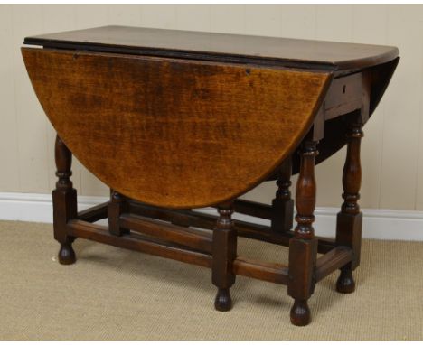 An 18th Century oak oval Gate-leg Table with single drawer on baluster turned and square legs united by square stretchers, 3f