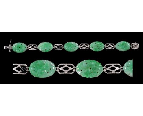 A Jade Bracelet having five oval carved and pierced jade plaques with pierced links between on hidden clasp in white gold, st