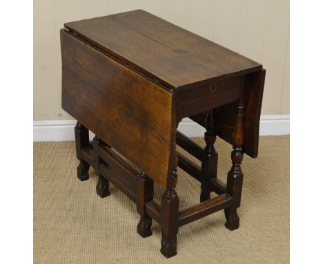 An early 18th Century oblong Gate-leg Table fitted single drawer on baluster turned and square legs united by square stretche