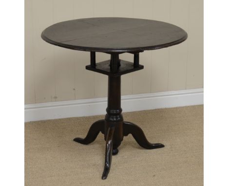 An 18th Century oak Pillar Table with circular top on bird-cage support, gun barrel turned column and tripod base, 2ft 4in di