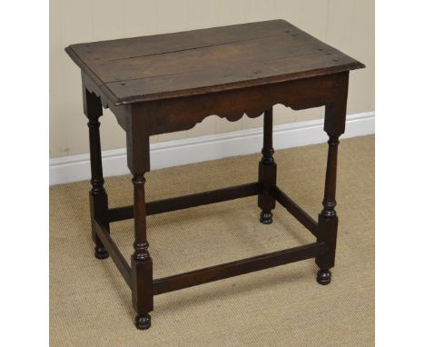 A 17th Century oak Side Table with moulded top above shaped frieze on gun barrel turned and square legs united by square stre