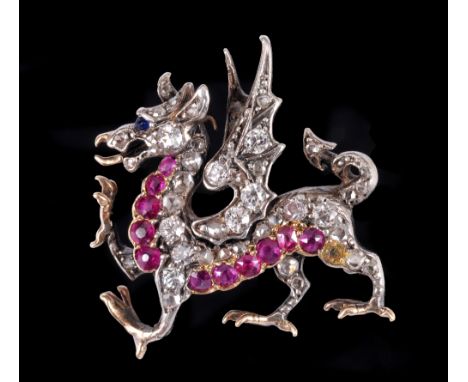 A Ruby and Diamond Dragon Brooch with sapphire cabochon eye, set throughout old and rose-cut diamonds and round rubies in sil