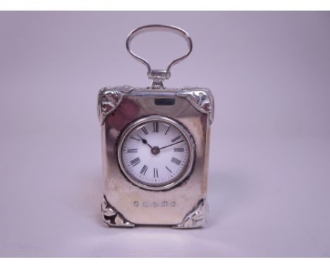 A Victorian silver cased miniature Carriage Clock with white enamel circular dial, ornate corner mounts and handle, Birmingha