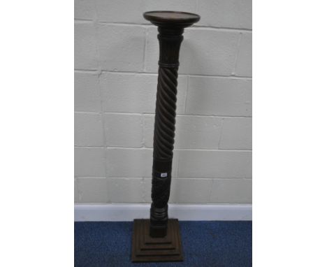 A 20TH CENTURY OAK PLANT STAND, with a dished top, foliate details, a spiral support, on a four stepped base, height 136cm, c