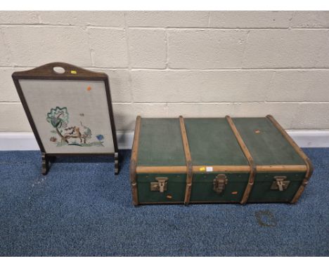 A GREEN CANVAS TRAVELING TRUNK, width 93cm x depth 54cm x height 30cm, along with another trunk, and a fire screen, condition