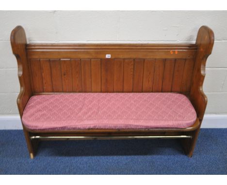 A 20TH CENTURY PINE PEW, with a tubular metal rest, width 130cm x depth 51cm x height 99cm, condition report: later upholster