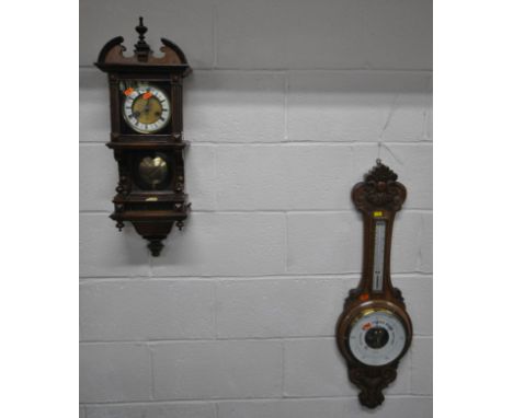 A 20TH CENTURY WALL CLOCK, with a broken arch pediment, a single finial, a square glass door enclosing a brass and enamel dia