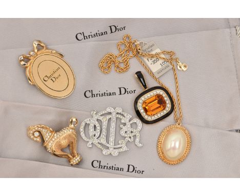 AN ASSORTMENT OF 'CHRISTIAN DIOR JEWELLERY' to include a large faux pearl pendant necklace, an AF horse brooch, an AF monogra