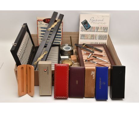 AN ASSORTMENT OF WRITING EQUIPMENT, to include a glass inkwell, a pewter inkwell, two parallel rulers, two pen display cases,