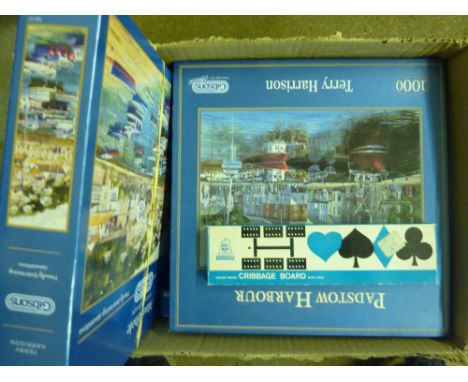 A box containing puzzles and a Cribbage board