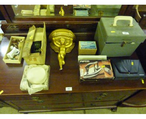 A case of singles; three irons; a cherub decorated wall bracket; a Stuart pump etc.