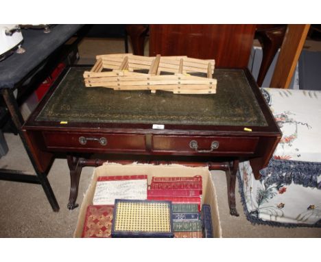 A sofa table with green leather inset top fitted two drawers; and a folding wine rack 