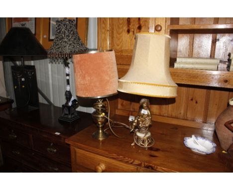 A brass and onyx table lamp decorated with a cherub and one other brass table lamp and shade