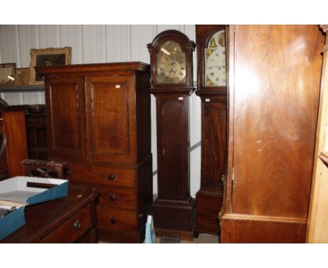 A George oak longcase clock by George Washbourne, the arched brass spandrel dial with eight day movement and full length trun