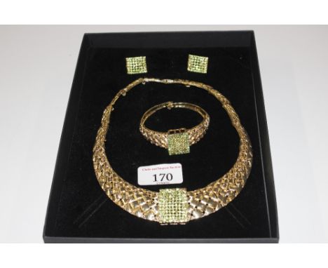 A boxed gilt metal and green stone set necklace, bangle and ear-rings 