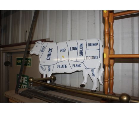 An enamel cow sign 