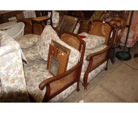 A Bergere suite comprising of a three seater sofa and two matching armchairs 