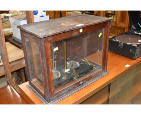 A set of lab scales in glazed case