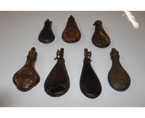 A collection of vintage brass and leather shot and powder flasks