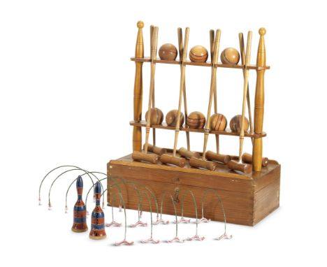 A miniature table croquet setFirst half 20th centuryWith eight mallets, all with turned handles together with a stand, a pine