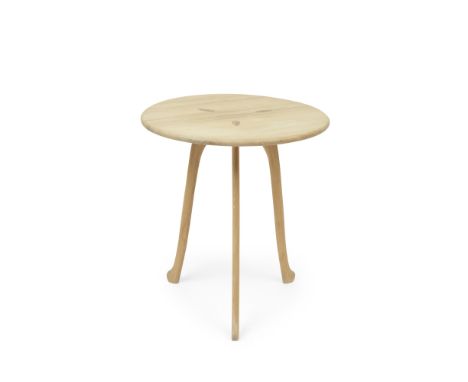 A maple 'Mad Axe' tableDesigned by Sir Terence ConranThe circular top on three supports,  66cm wide x 66cm deep x 73cm high, 