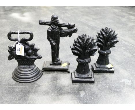 Four cast metal doorstops, harvest bundles chimney sweep etc