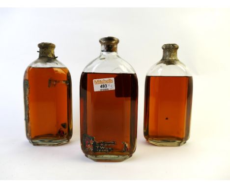 Three hexagonal vintage bottles of alcohol - two with partially decayed labels, no makers marks to glass bottles