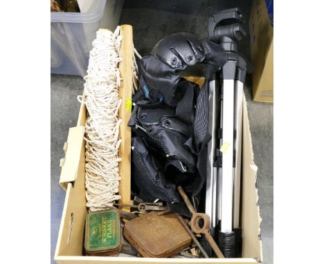 Box of knee pads and protective gear, camera tripod, hammock and tools