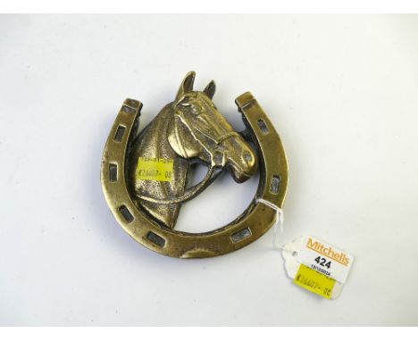 Brass horseshoe formed door knocker