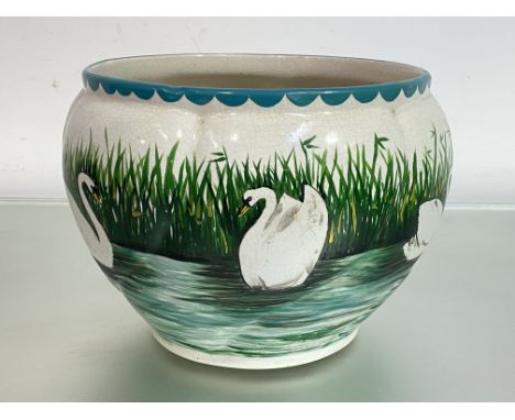 A Wemyss pottery Coombe jardiniere, painted with swans on a river by a reeded bank, impressed mark. Height 19.5cm. Provenance