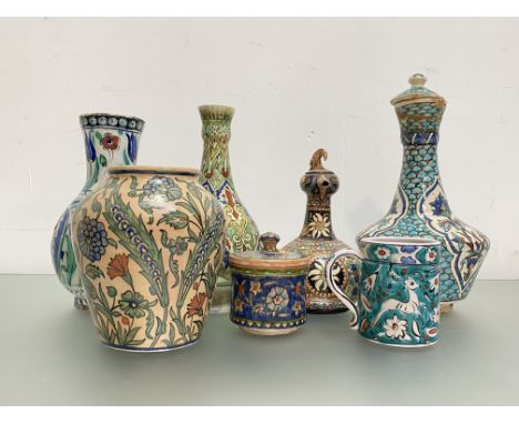 A group of Middle Eastern pottery vessels, four with decoration of Iznik design comprising: a Jerusalem baluster vase; a mug;