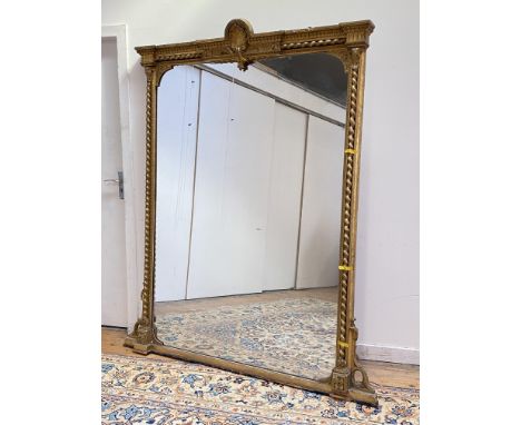 A large 19th cenutry gilt-framed overmantel mirror, the gesso, carved wood and composition frame surmounted by a shell pedime