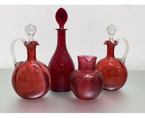 A group of 19th century and later ruby and cranberry glass comprising: a pair of ribbed decanters, each with "celery" handle 