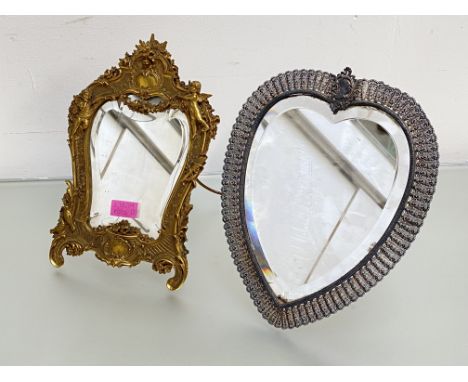 A late 19th century gilt-metal easel mirror in the Rococo taste, the shaped bevelled plate within a conforming frame cast wit