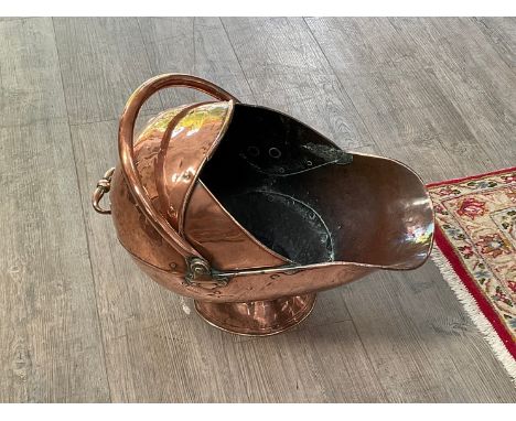 A Victorian copper helmet coal scuttle, studded detail 