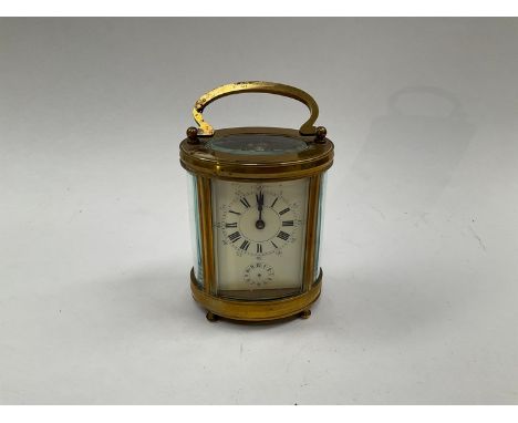 A brass cased carriage clock of rounded form 
