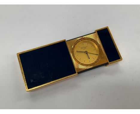 A Dupont of Paris travelling pocket alarm clock, gilt metal with blue panels 