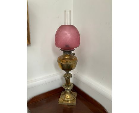 A 19th Century unusual oil lamp with cranberry etched glass shade, 'The Union Burner' ornate acanthus brass base, 73cm tall i