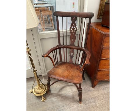 A 19th Century Windsor wheel back armchair, high back with stick supports, crinoline stretcher, elm seat 