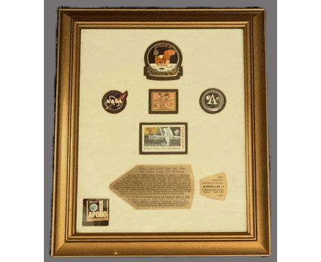 First Man on the moon stamp. Mounted and frame with information plaque, NASA and Apollo badges. Approx overall size 12x10inch