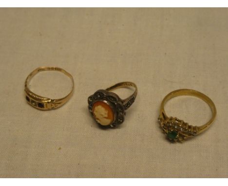 A 9ct gold and silver mounted dress ring set a female oval cameo portrait; 9ct gold dress ring set with garnets and one other