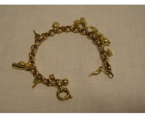 A 9ct gold chain link charm bracelet supporting numerous 9ct gold and other charms