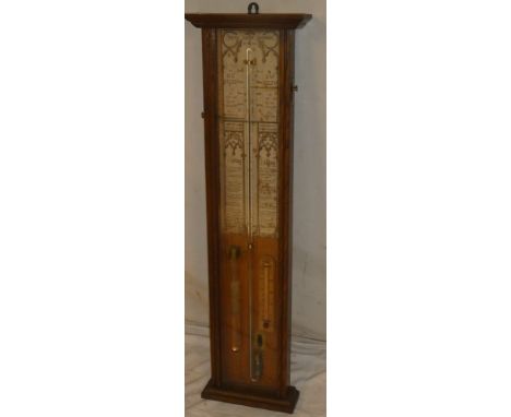 An old Admiral Fitzroy barometer with descriptive paper label and additional thermometer within oak glazed case