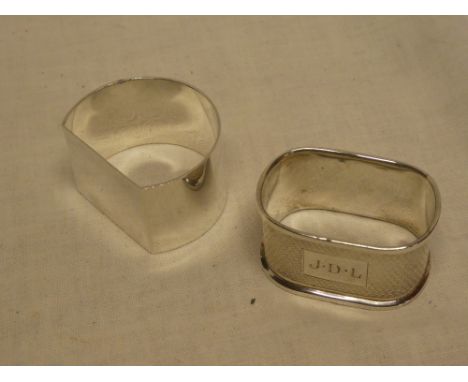 A good quality silver semi-circular napkin ring and one other silver engine turned napkin ring (2)