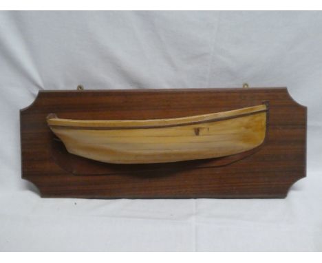 A good quality polished wood half boat model of a working sail boat by Henry Wylie mounted on a polished wood plaque, signed 